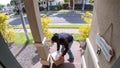 Person stealing delivery package from porch steps, surveillance camera view Royalty Free Stock Photo