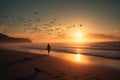 A person strolling on a sandy, empty beach as the sun sets in the background, casting a warm glow Royalty Free Stock Photo