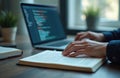 Person studies computer science using book and laptop. Student explores coding. Learning programming, data, software development. Royalty Free Stock Photo