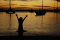 Person swimming in a sea and enjoying the sunset in Grand Baie, Mauritius