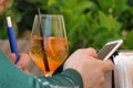 a person takes a aperitif and uses the telephone