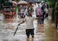 A person takes selfie standing on a waterlogged road, after heavy rainfall, on October 6, 2023 in Guwahati, Assam, India. Severe w