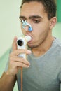 Person taking lung finctionality test with spirometry device