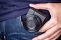 Person taking out a pocket camera out of pocket Royalty Free Stock Photo