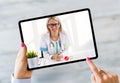 Person talking with doctor on video call on tablet