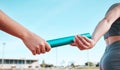 Person, team and hands with baton in relay, running marathon or sports fitness on stadium track. Closeup of people Royalty Free Stock Photo