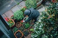 A person tending to a tiny garden outside their small living space