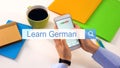 Person texting learn German phrase on smartphone search bar, online education