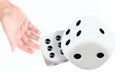 Person throwing or rolling dice against white background