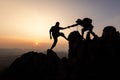 person on top of mountain. silhouette of people team hiking to top of mountain in sunset, climbing team success on the mountain. Royalty Free Stock Photo