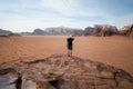 Person on a top of mountains in a desert. Sunset view. Nature. Tourist people enjoy a moment in a nature. Wadi rum national park -