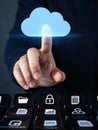 Person touching a glowing blue cloud icon symbolizing cloud computing and digital data access Royalty Free Stock Photo