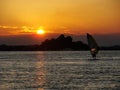 Person training windsurf in the holidays with the sunset in the background Royalty Free Stock Photo