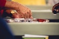 Person treats the red wine with small glasses to churchgoers to observe communion Royalty Free Stock Photo