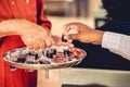 Person treats the red wine with small glasses to churchgoers to observe communion Royalty Free Stock Photo