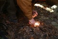 Person tries to make a fire with a flint