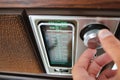 Person Tuning an Old Fashioned Radio