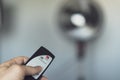 Person turning on a fan in the middle of a heat wave with a remote control