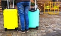 Person with two colored suitcases. Bags for a trip. Colored Bags. suitcase for travel Royalty Free Stock Photo