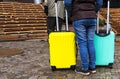 Person with two colored suitcases. Bags for a trip. Colored Bags. suitcase for travel Royalty Free Stock Photo