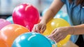 Person tying colorful balloon Royalty Free Stock Photo