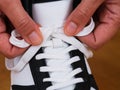 A person tying shoe laces