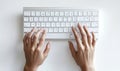 Person typing on a computer keyboard overhead view with clean background Royalty Free Stock Photo
