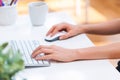 Person typing at on her office computer