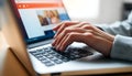 A person typing on a laptop computer using their fingers Royalty Free Stock Photo