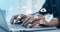 Person typing on laptop with cybersecurity and cloud computing icons Royalty Free Stock Photo