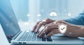 Person typing on laptop with cybersecurity and cloud computing icons Royalty Free Stock Photo
