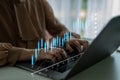 Hands typing on laptop with digital graphs and data analysis on screen, representing financial growth and market Royalty Free Stock Photo