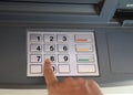person typing the secret code into the ATM machine keyboard Royalty Free Stock Photo