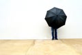 Person with an umbrella in front o a wall Royalty Free Stock Photo