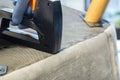 Person upholstering an armchair using a heavy duty stapler. Do it yourself home project Royalty Free Stock Photo
