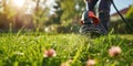 Person Uses Cordless Grass Trimmer To Cut Lawn, Closeup Shot