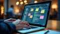Person uses laptop with Kanban board framework for agile software development. Coding on screen. Person manages tasks. Project