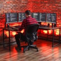 A person uses multiple computer screens at a desk Royalty Free Stock Photo