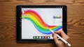 Person Using Apple Pencil on iPad with Rainbow Digital Art Royalty Free Stock Photo