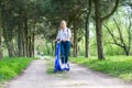 Person using blue electric scooter in the park