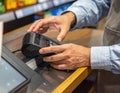 Person Using Card Reader at Retail Checkout Counter Royalty Free Stock Photo