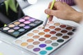 Person using a colorful make-up palette in backstage Royalty Free Stock Photo
