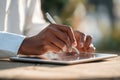 Person Using Digital Pencil to Write on Tablet in Natural Light, Showcasing Modern Technology Interaction and Creativity Royalty Free Stock Photo