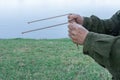 Person using dowsing rods to discover the source of water Royalty Free Stock Photo