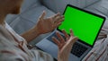 Person using green laptop talking online closeup. Manager working home remotely