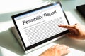 Man Typing Feasibility Report On Laptop Royalty Free Stock Photo