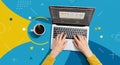 A person is using a laptop, coding or designing with software open on the screen. The