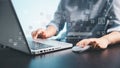 A person using a laptop and computer mouse with floating digital interface icons, representing online technology, data management Royalty Free Stock Photo
