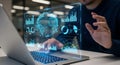Person using a laptop with holographic data visualization and futuristic interface Royalty Free Stock Photo