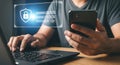 Person Using Laptop and Mobile Phone for Online Security Authentication Royalty Free Stock Photo
